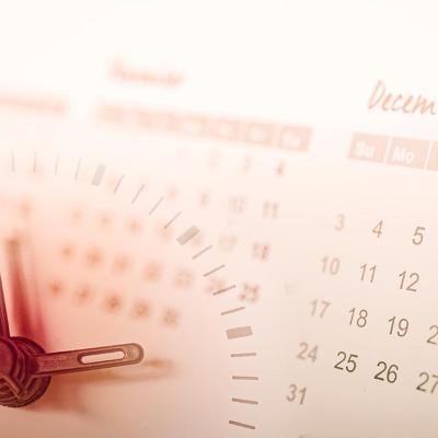 Hands of a clock are overlaid in a background of a calendar.