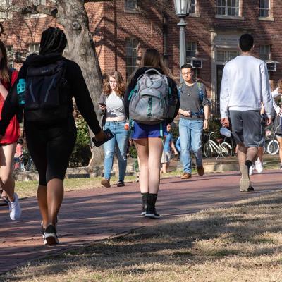 College students walking on campus grounds.