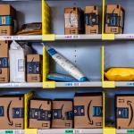 Three rows of shelves filled with Amazon packages