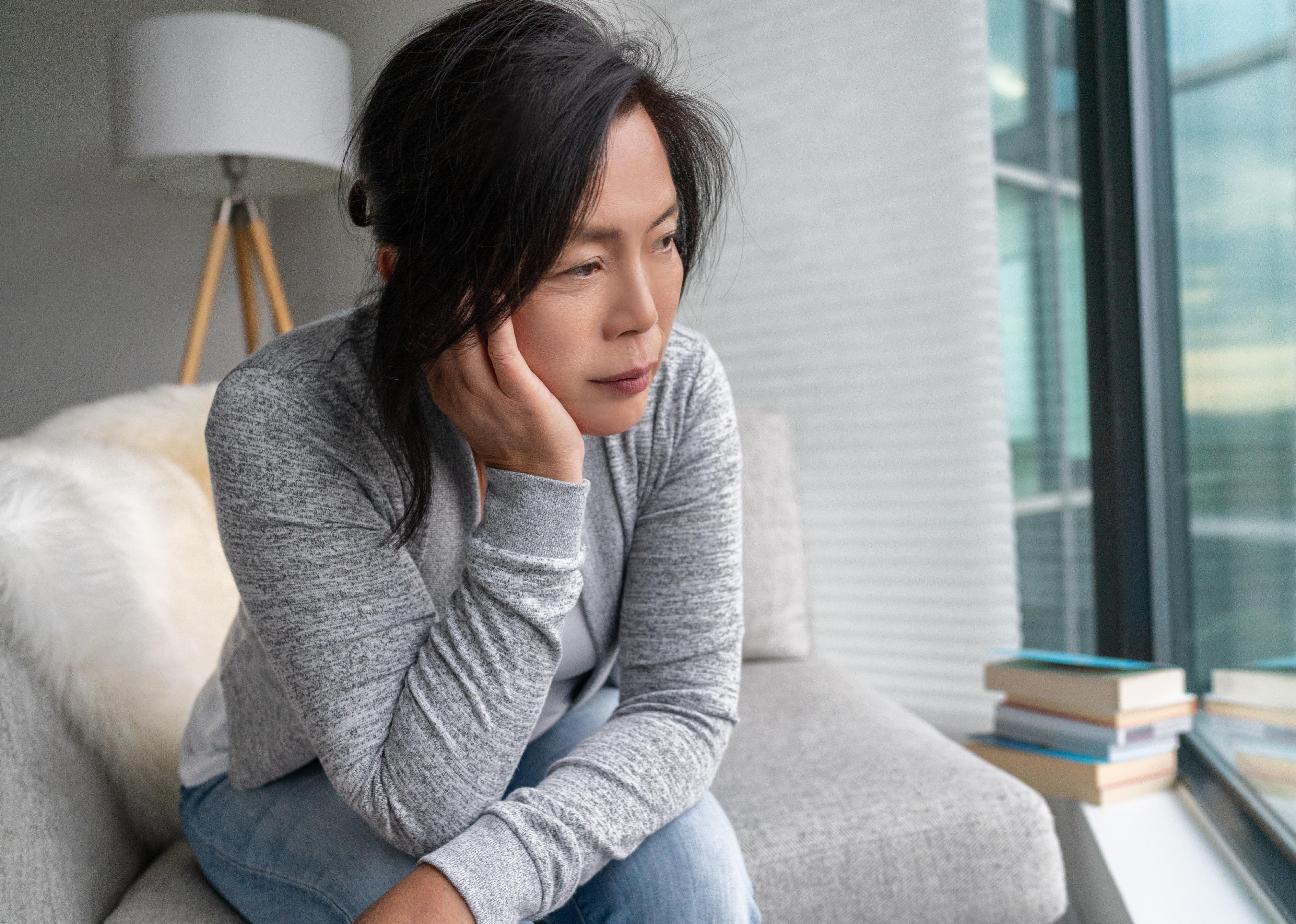 Woman on couch looking sad