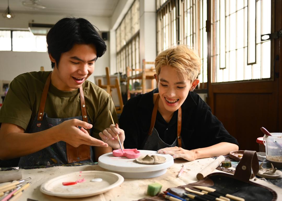 Two students working on ceramics.