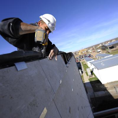 Construction workers building an eco-friendly school