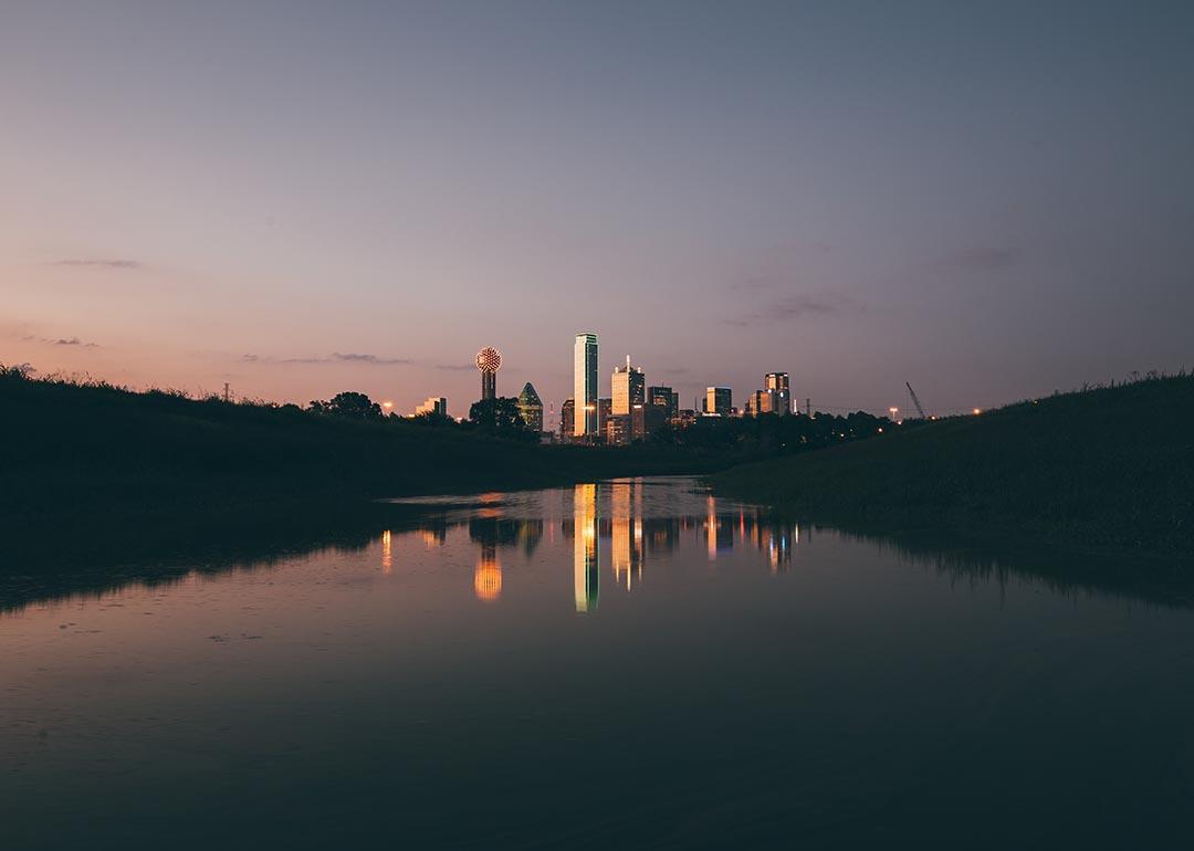 Dusky photo of Dallas skyline at night.