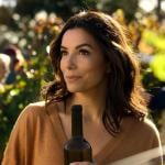 Eva Longoria holds a bottle of wine in the 2024 Apple TV+ series 'Land of Women.'