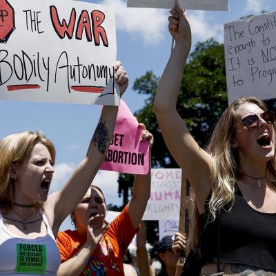 Abortion rights activists yell and hold up signs during a protest in the wake of the decision overturning Roe v. Wade outside the U.S. Supreme Court Building on June 25, 2022 in Washington, DC.