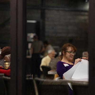 An election worker hand counts ballots inside of The Edge, a winery in Fredericksburg on Mar. 5, 2024.