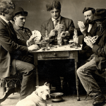 A black and white 1909 photo of five men playing poker around a table.