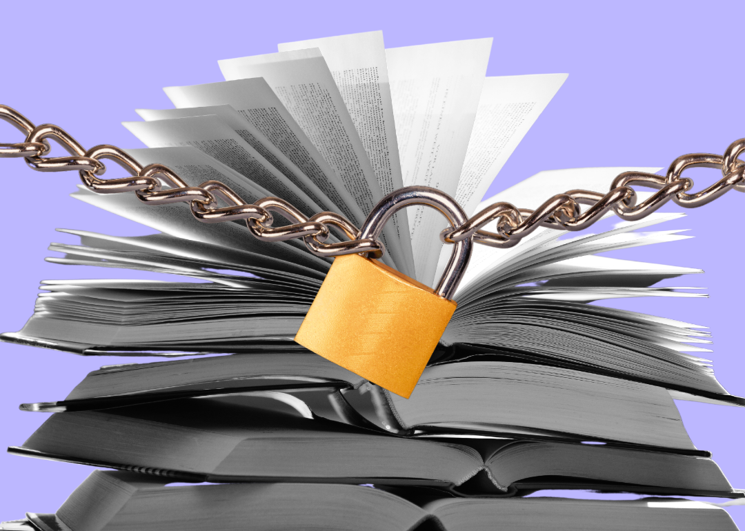 A stack of books stand behing a padlock and chains