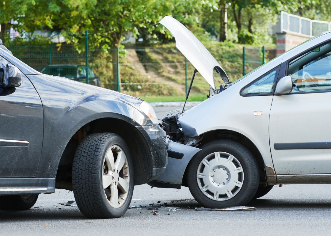 A car crash with two vehicles driving into each other on a street.