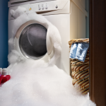 laundry machine overflowing with soap suds